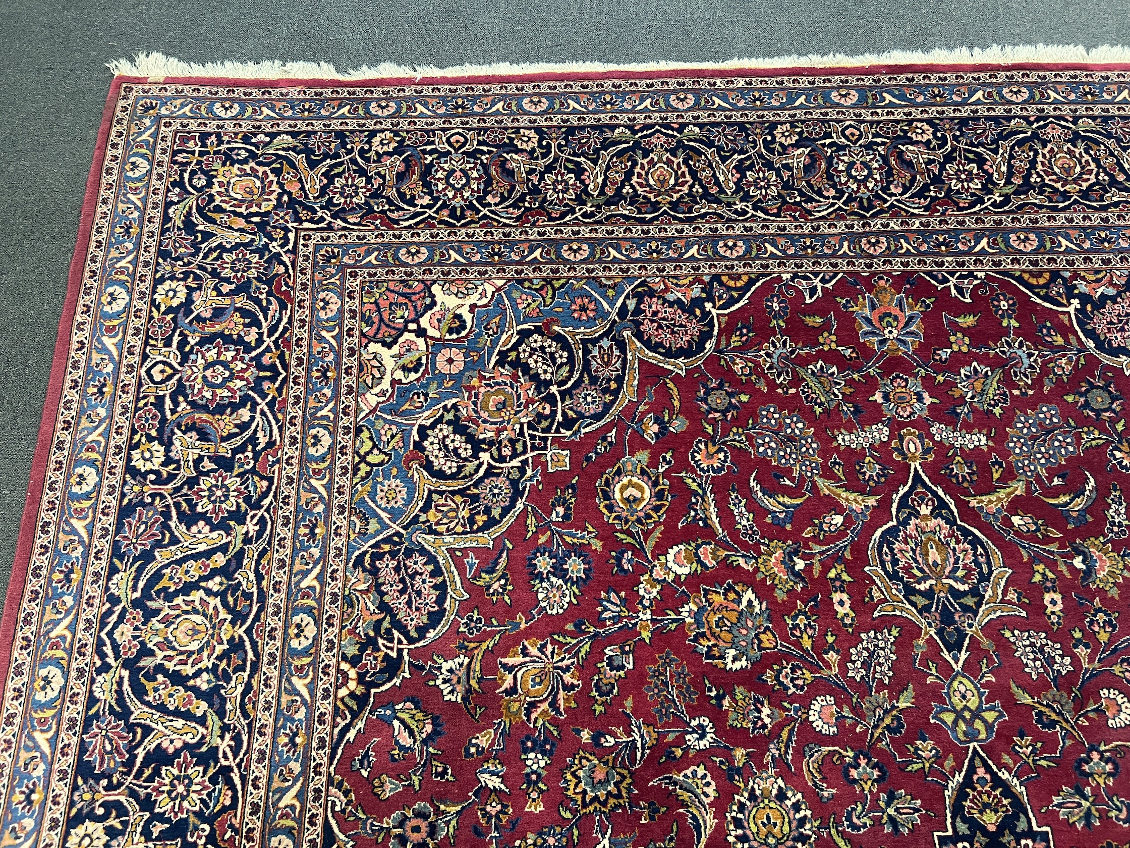 A Kashan burgundy ground carpet